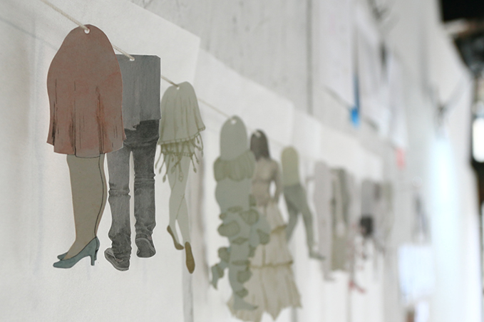 illustrated paper cut-outs on a string.